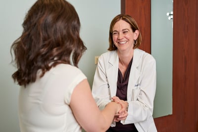 A Moreland OBGYN doctor shaking hands with a new OB patient on her first trimester exam visit