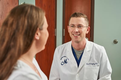 Woman patient talking to her Moreland OB-GYN PCOS doctor about her PCOS treatment options in a clinic setting