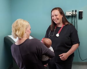 New mom with baby at a fourth trimester, 6 week check-up with provider, Dr. Nelson from Moreland OB-GYN