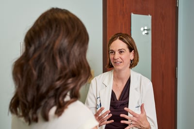 A moreland OB-GYN doctor, Dr. Sponagle, talks to a patient in an exam room about vaginal dryness treatments