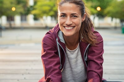 Woman getting ready to workout after reading exercise tips for after having kids