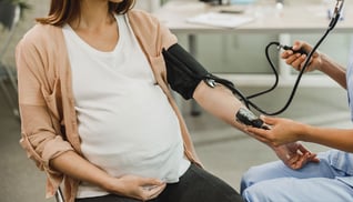 Gynecology-Nurse-Checking-The-Blood-Pressure-Of-Pregnant-Woman