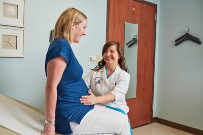 Obstetrician performing checks with a newly pregnancy woman.