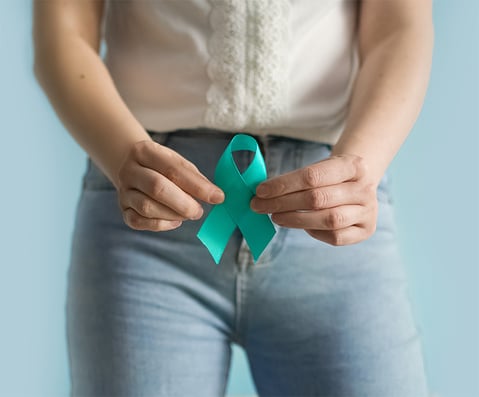 Woman holds in his hand Teal ribbon Symbolic for PCOS