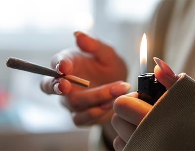 moking joint with marijuana in female hands