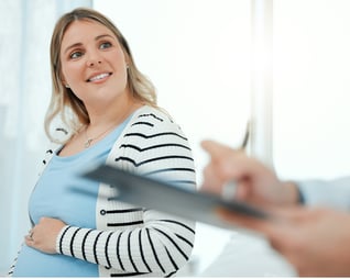pregnant woman and doctor with clipboard
